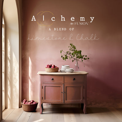 Wooden cabinet painted in rusty Sienna from Alchemy by Fusion paint range with fruit bowls and a plant against a dusty pink wall 