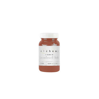 Bottle of Alchemy paint in earthy rust Sienna on a white background