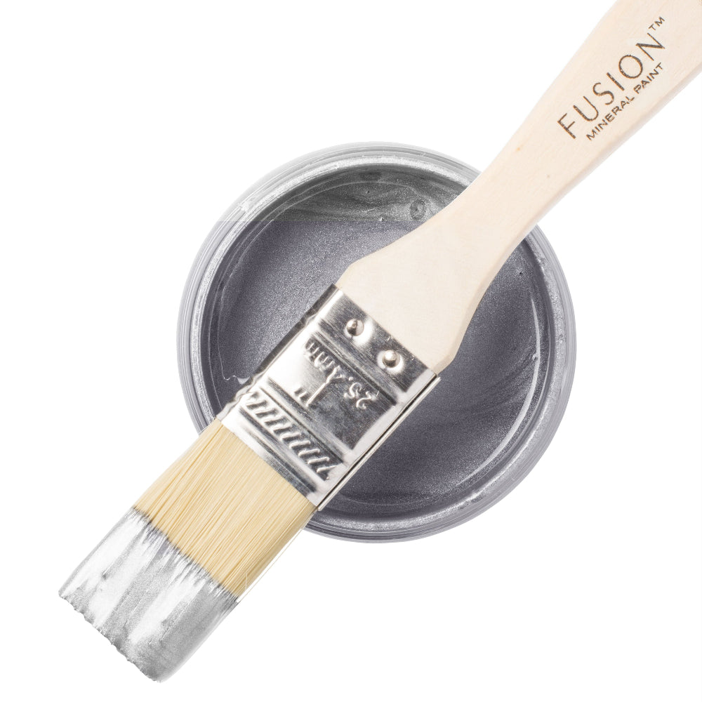 Silver Metallic paint with a brush and open paint jar on a white background