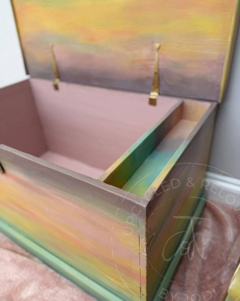 Inside of a toy chest painted in soft pink with pastel ombre detail on the lid, upcycled by Upcycled & Reloved by Jodi using Fusion Mineral Paints.