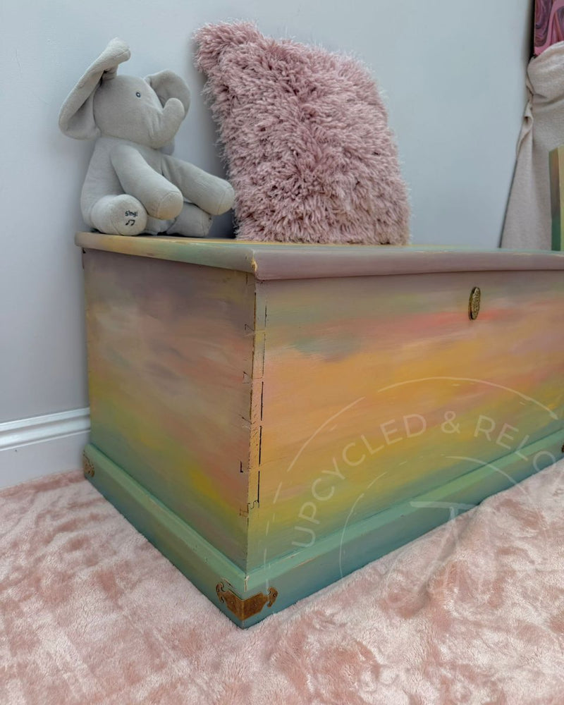Close-up of a repaired Edwardian toy chest with pastel hand-painted ombre finish using Fusion Mineral Paint.
