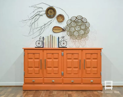 Cabinet painted in Tuscan Orange from Fusion Mineral Paint range with decorative items on a white wall