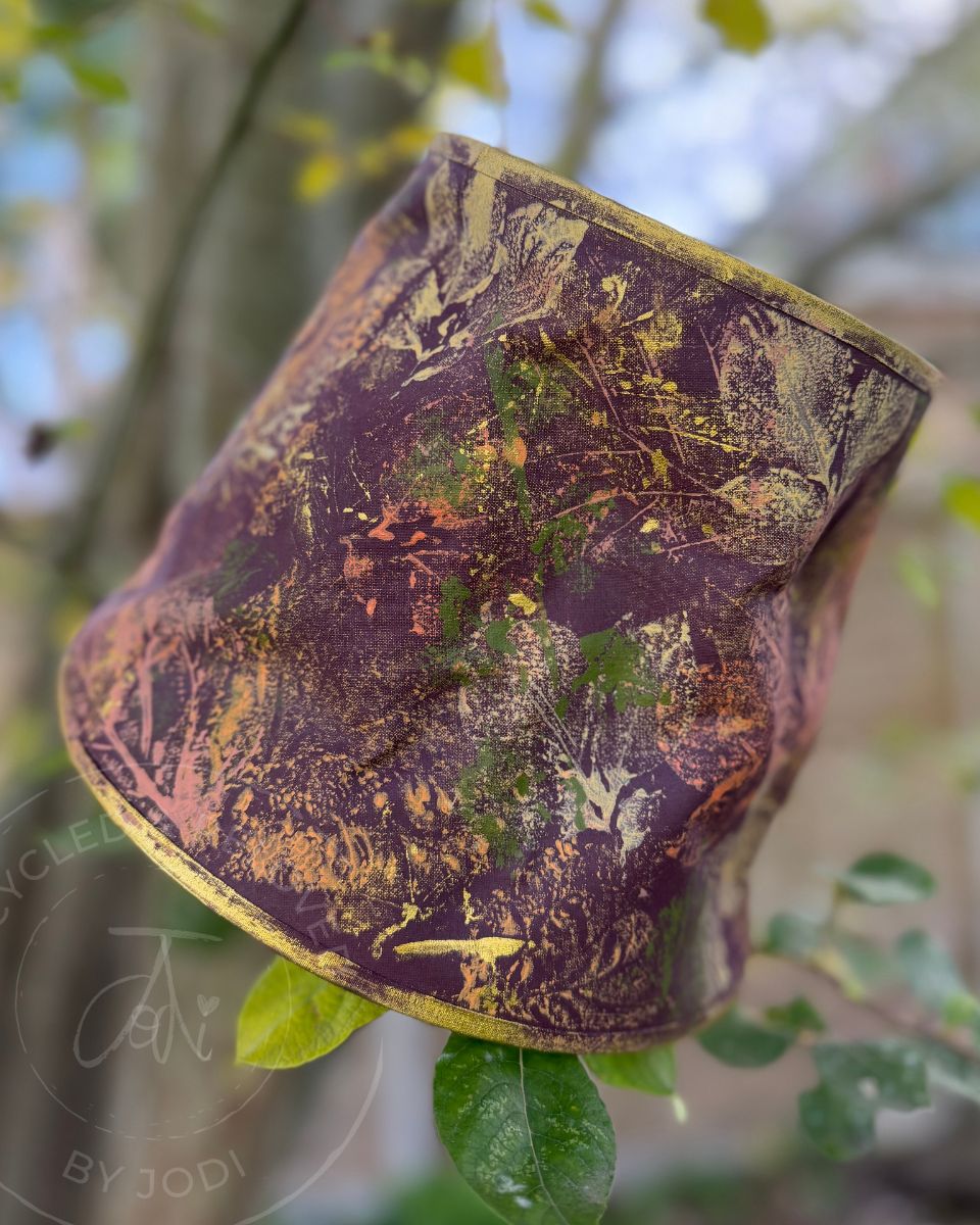 A rustic upcycled lampshade with autumn leaf patterns in multi colours featuring gold accents. Upcycled lampshade for UK delivery