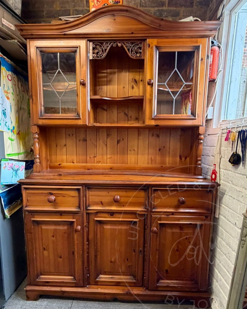 Orange pine Welsh dresser before upcycling, with shiny varnish and traditional carved details.