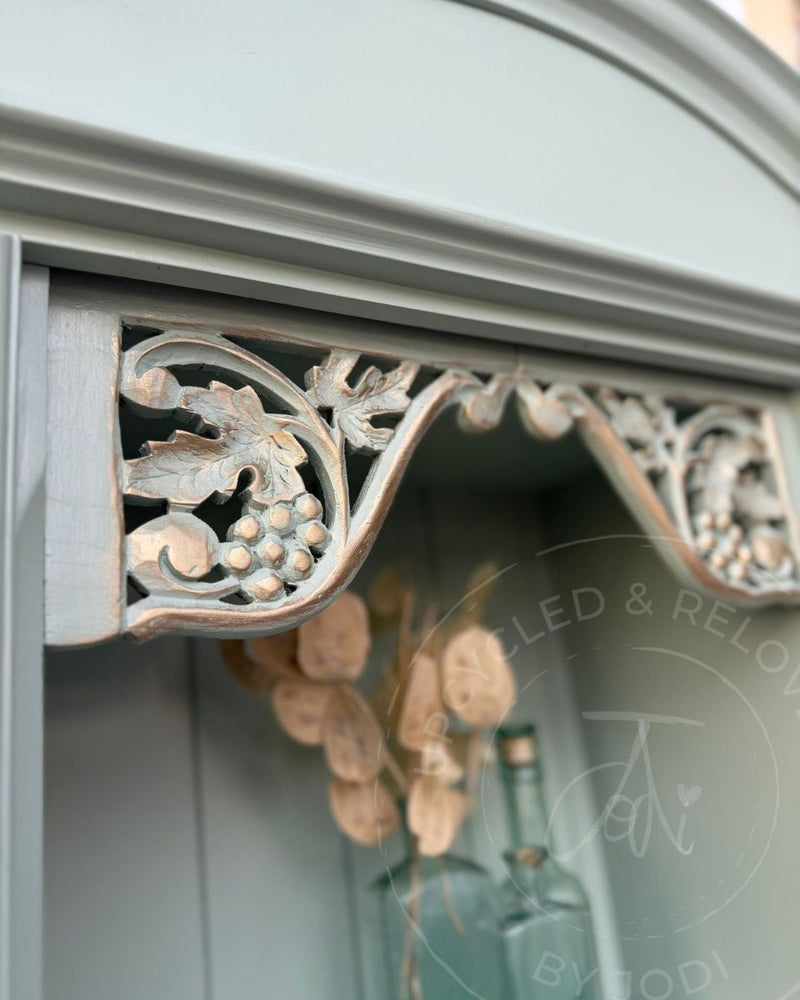 Close-up of carved grape detail on a painted Welsh dresser with subtle gold gilding, refinished by Upcycled & Reloved by Jodi.