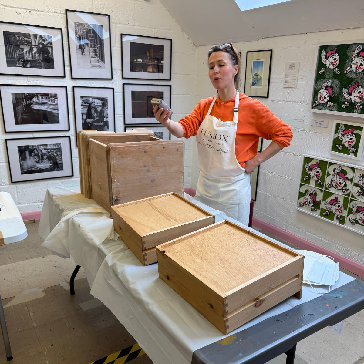 Lady preparing a chest of drawers for upcycling by sanding