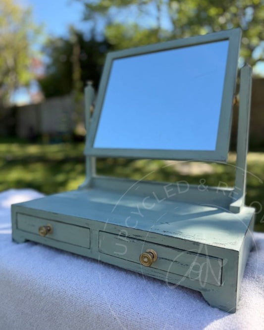 An upcycled small vintage dressing table mirror with two drawers is finished in soft greens from Fusion Mineral Paint with an aged, distressed effect. 