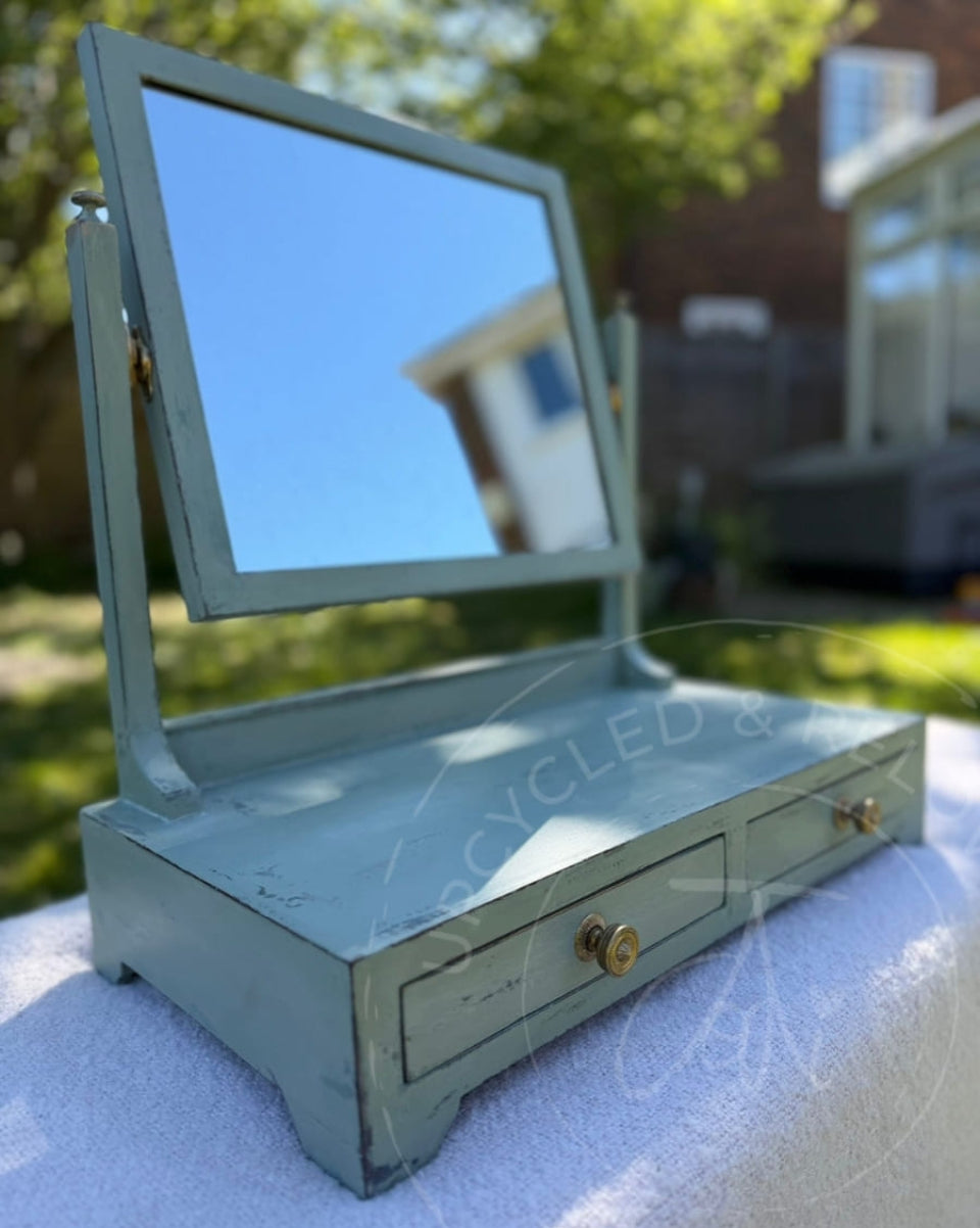 An upcycled small vintage dressing table mirror with two drawers is finished in soft greens from Fusion Mineral Paint with an aged, distressed effect. 
