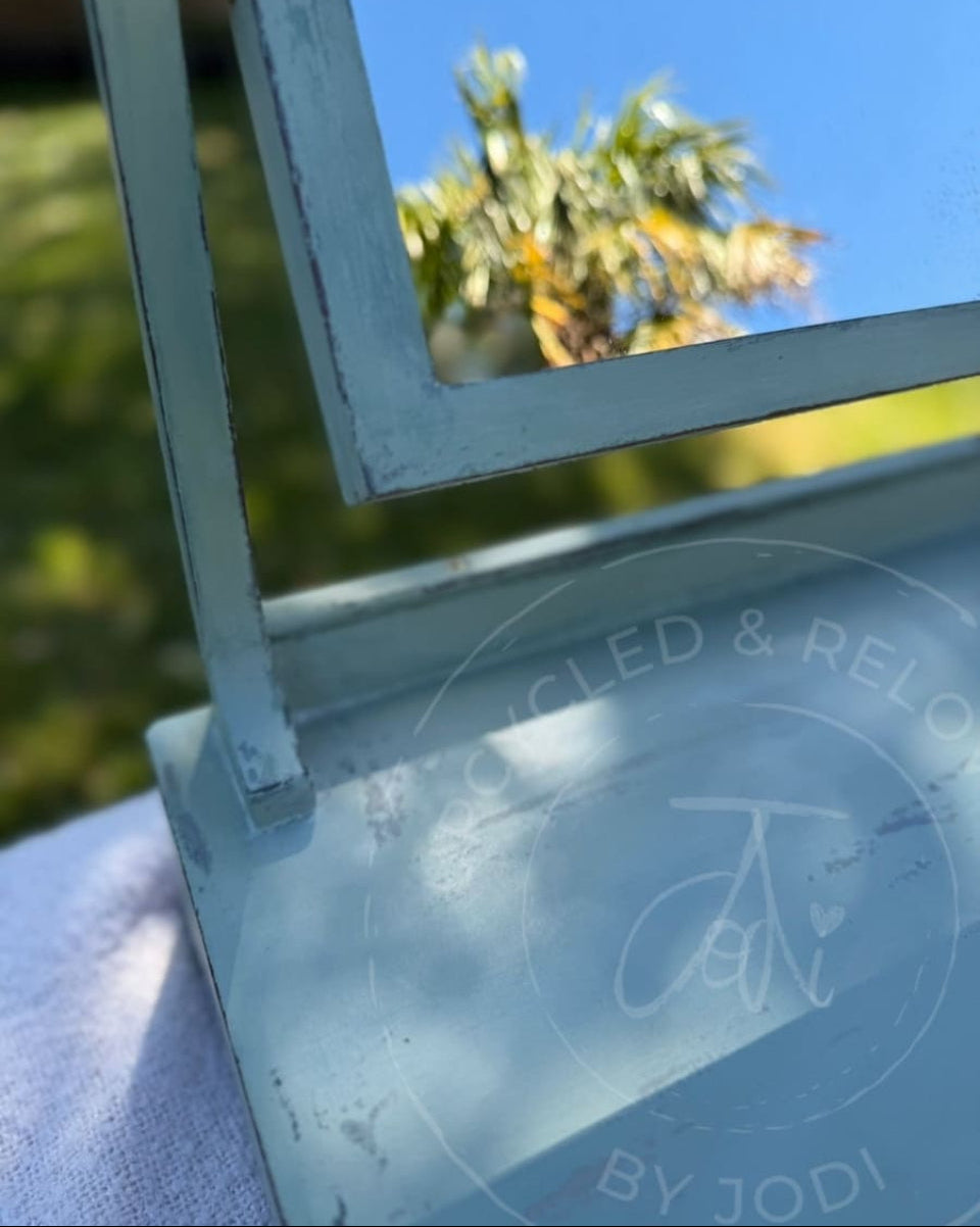An upcycled small vintage dressing table mirror with two drawers is finished in soft greens from Fusion Mineral Paint with an aged, distressed effect. 