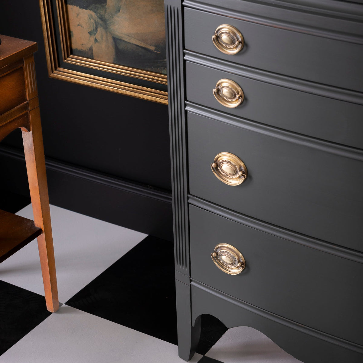 Dark dresser painted in Wellington Fusion Mineral Paint with gold knobs on a black and white checkered floor