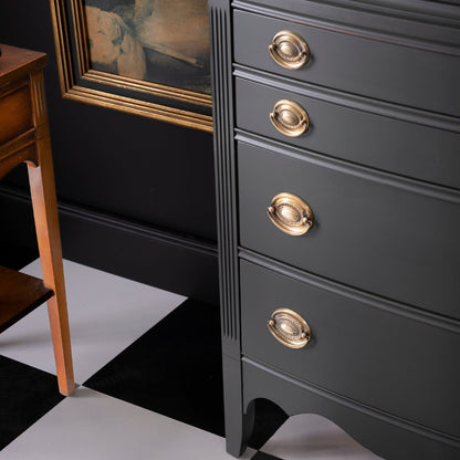 Dark dresser painted in Wellington Fusion Mineral Paint with gold knobs on a black and white checkered floor