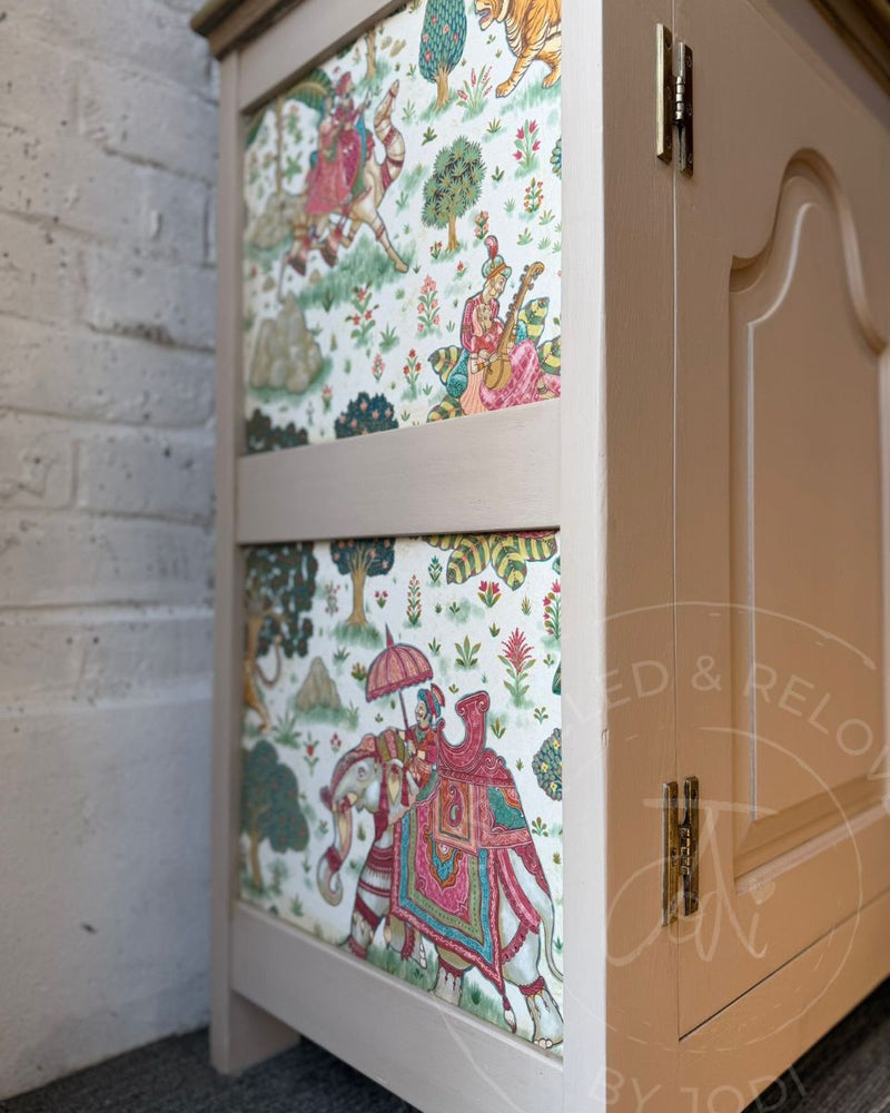 Side panel of a recycled Welsh dresser, finished with colourful Indian-inspired wallpaper decoupage against a painted Fusion Alchemy Sandstone base