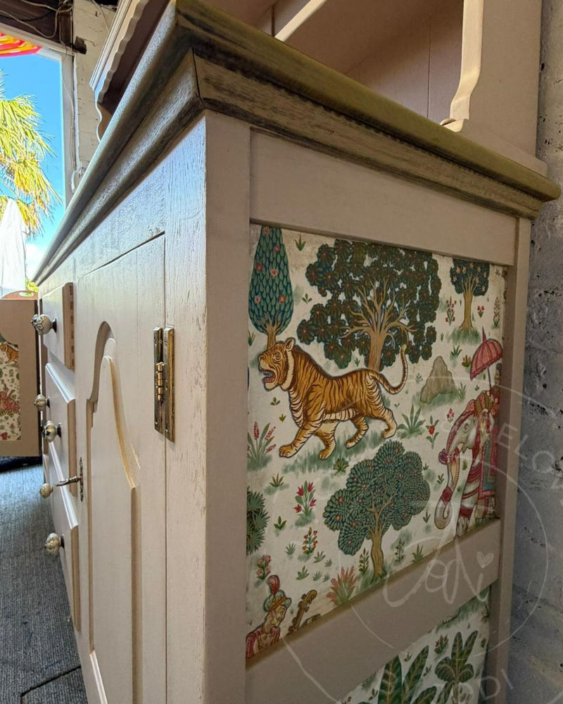 Side panel of a recycled Welsh dresser, finished with colourful Indian-inspired wallpaper decoupage against a painted Fusion Alchemy Sandstone base