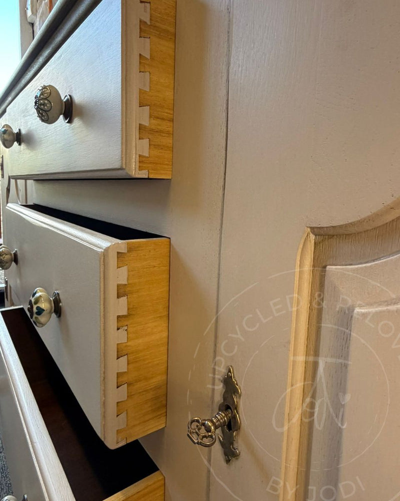 Close-up of wooden drawers, painted in Fusion Mineral Paint Alchemy Sandstone, with dove-tail joins accentuated against the wood grain
