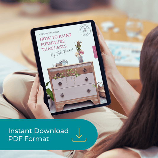 Person holding a tablet with a DIY upcycling furniture ebook called how to paint furniture that lasts, written by Upcycled & Reloved by Jodi 