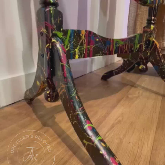Short video showing the detail on a standing dressing mirror that has been upcycled and painted in black with splatters of brightly coloured paint